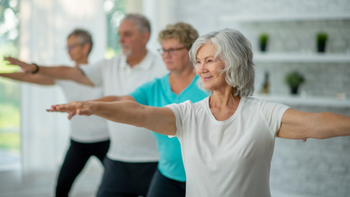 Group of seniors practicing yoga, symbolizing healthy aging and balance.