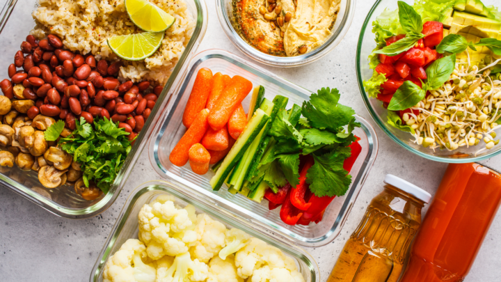 Different kinds of veggie and leafy foods in a glass container